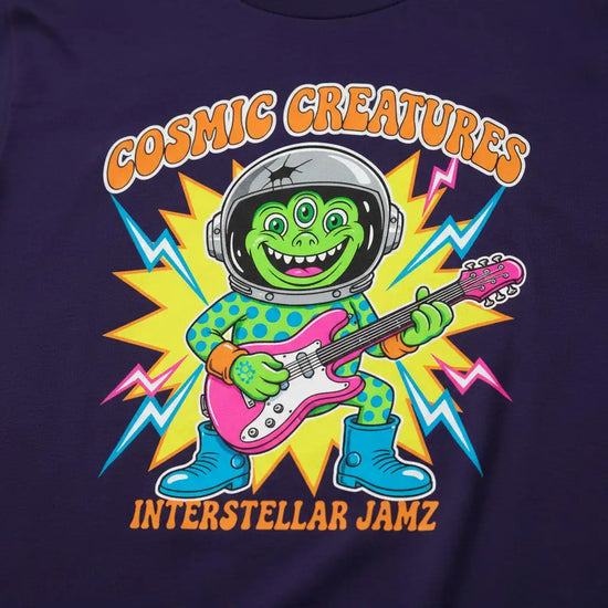 Cosmic creatures interstellar jamz t-shirt with green alien playing pink electric guitar, wearing blue astronaut helmet and boots.