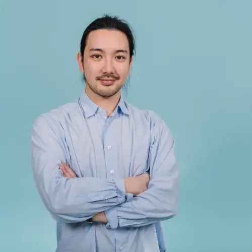 Light blue button-down shirt with long sleeves and a classic collar, made of cotton.