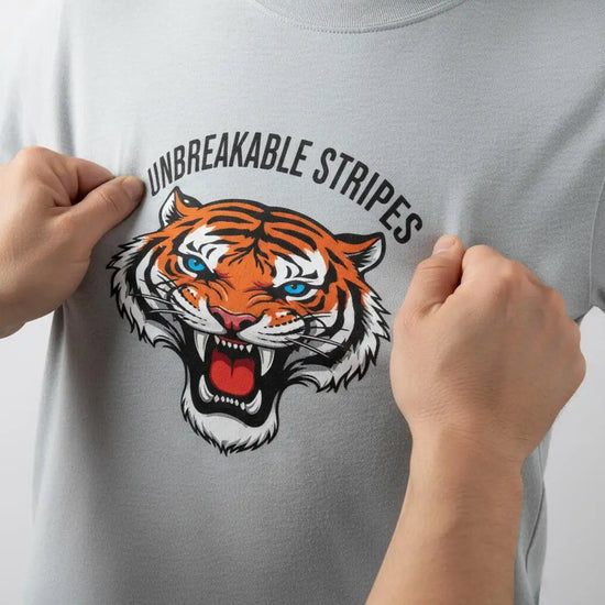 Tiger stripe t-shirt with vibrant orange and black stripes, white accents, and bold text.